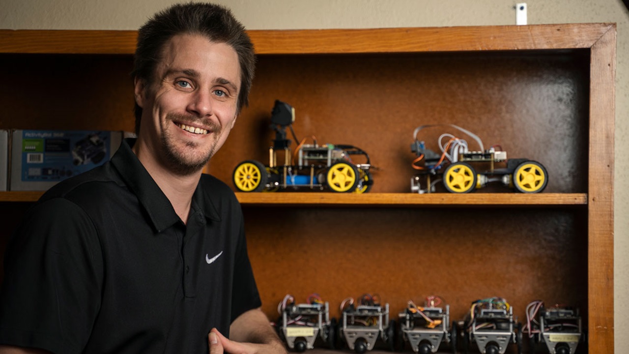 Nicholas Rasmussen sits in front of tiny machines in the computer science lab. Nicholas Rasmussen sits in front of tiny machines in the computer science lab.