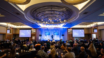 A crowd watching the keynote speaker at the Prairie Family Business Conference. A crowd watching the keynote speaker at the Prairie Family Business Conference.