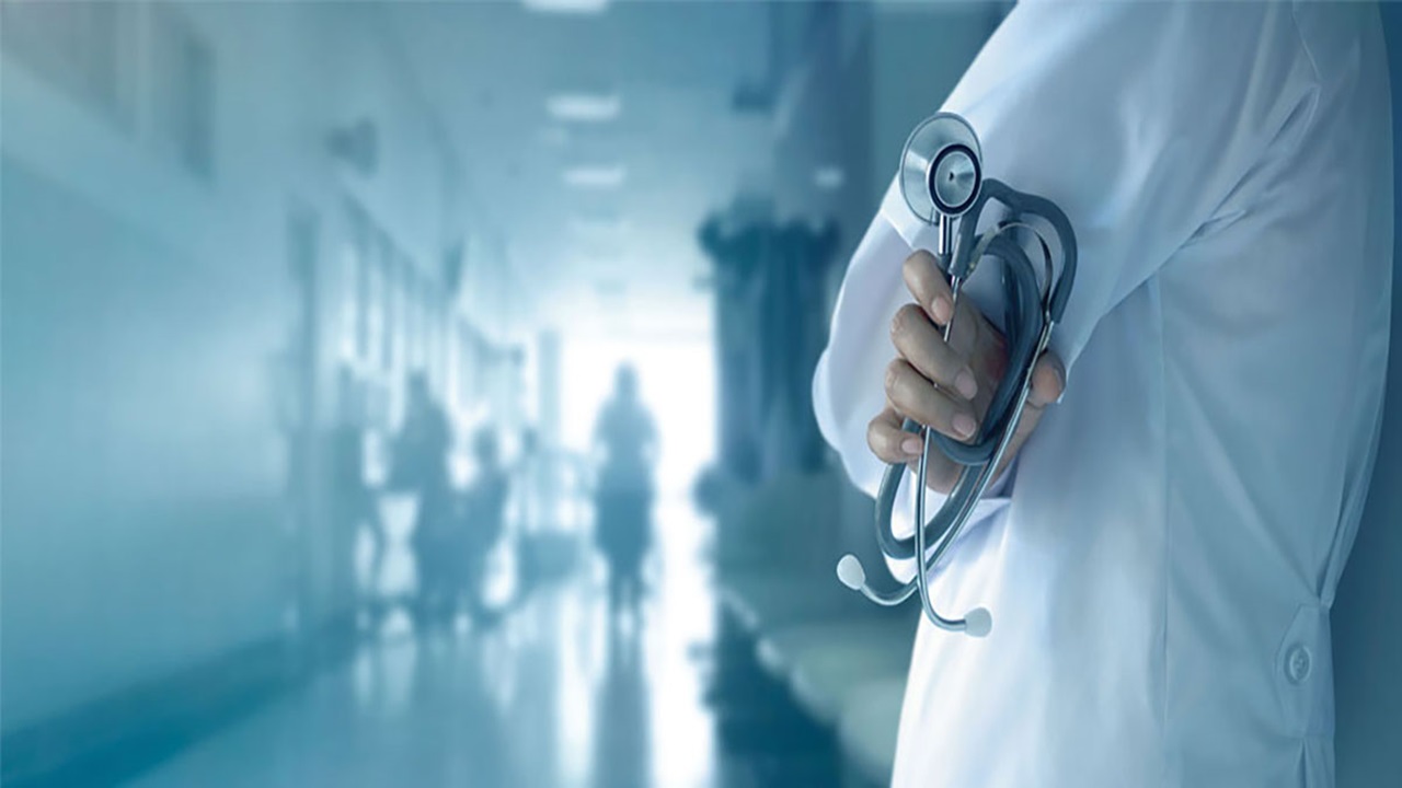 A photo of a doctor clutching a stethoscope. A photo of a doctor clutching a stethoscope.