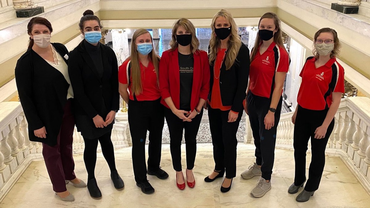 Dental students pose for a picture on stairs in the South Dakota capitol building.