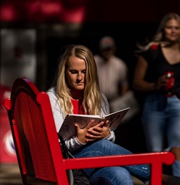 A student reading a book outside.