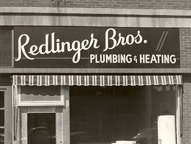 Outside of older redlinger bros plumbing and heating, black and white