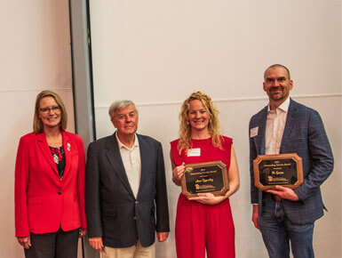 President Sheila K. Gestring stands with USD alumni during the Accounting & Finance Recognition dinner.