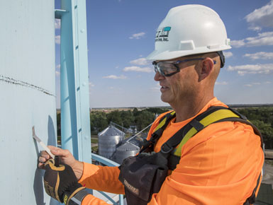 A Maguire Iron worker inspecting a water tank