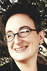 A portrait of Jillian Linster. She is looking off to the side and smiling.