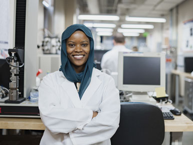 USD Student Shania Rehmudin standing with arms crossed in the lab