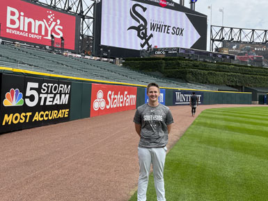 USD alumnus Aaron Trunt standing at the White Sox stadium where he works as biomechanist.
