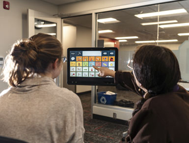 Elizabeth Hanson and a student use AAC technology.