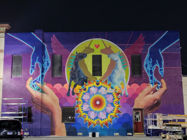 A photo of the nearly completed mural in downtown Vermillion taken at night.