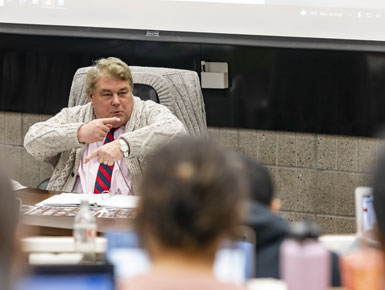 Professor Tom Horton talks with his hands while teaching a class