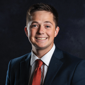 Tory Shafer, J.D., a 2025 USD Knudson School of Law graduate, poses for his headshot photo.