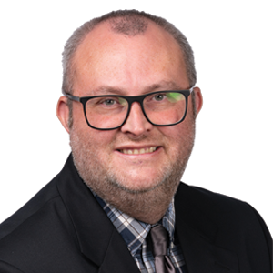 Justin Huston, J.D. ‘18, head of instructional services in the McKusick Law Library, poses for his headshot.