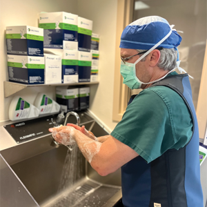 Dr. Brandt Becker washes and sterilizes his hands before heading into surgery.