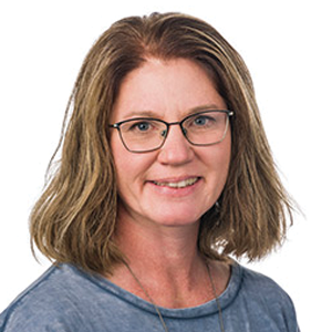 Wendy Knutson looks forward, smiling at the camera.