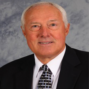 Gale Wiedow, Ph.D., looks forward, smiling at the camera with a blue background.