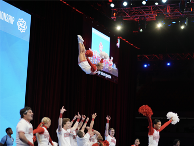 Elizabeth Boysen strikes a pose mid-air as part of a spirit squad competition performance.