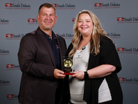 Kassandra Frey stands with someone and receives award