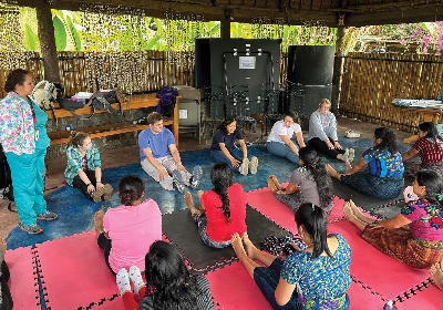 OT and PT students in Guatamala attending a class while kneeling.
