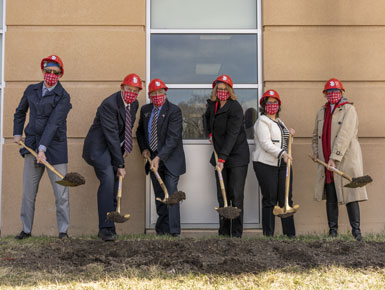 At the Center for Health Education ground breaking, USD leaders break ground with shovels to signify the beginning of the construction of the building.