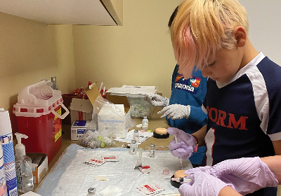 Young learners doing research during a Health Sciences camp.