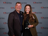 Kristi Livermont stands with someone and receives award