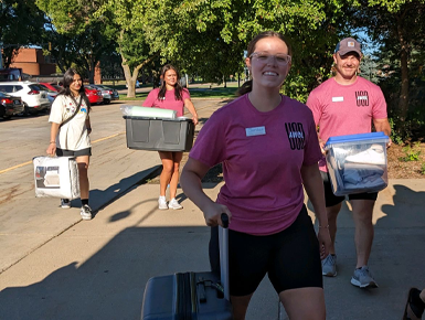 Students carry boxes and help move stuff into the dorms.