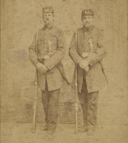 Henry Clay Butler, "Ed Dimmick and Henry Butler dressed in military style uniforms displaying Grand Army of the Republic (GAR) membership ribbons on their uniforms and GAR insignias on their caps.