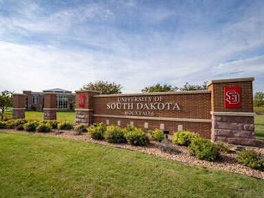 A close-up of the brick USD – Sioux Falls sign, which also shows the USD logo.