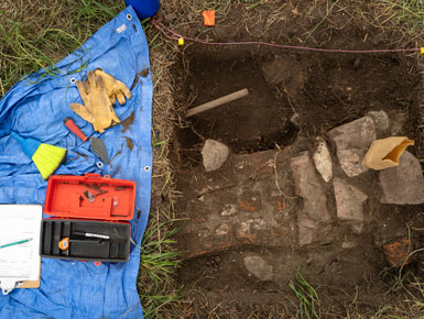 The stone structure that could be a wall that was found at the summer 2022 Susan Tuve Archaeology Field School.