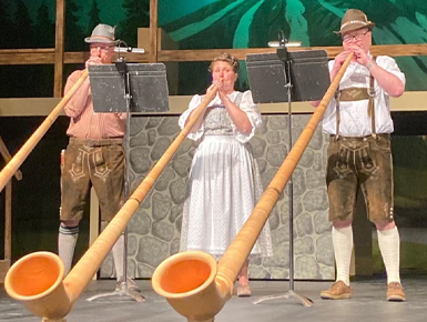 Kurt Hackemer, Amy Laursen and Todd Cranson playing their alphorns during the Vermillion Community's production of The Sound of Music