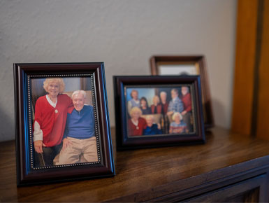 A close-up of the photos on McCahren's shelf, which include photos of her with family and friends.