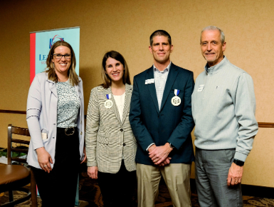 Alissa Matt, assistant vice president for marketing and university relations, poses with three members of the Leadership South Dakota Class of 2016 group.