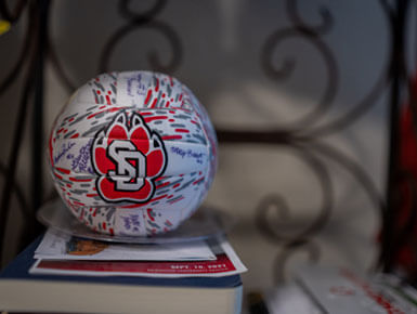 A photo of a signed USD volleyball that was gifted to McCahren for her donation to the volleyball team.
