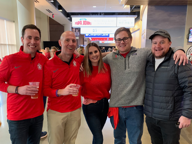 Ryan Bundmayr, Dean Neil Fulton, Molly Budmayr, Cash Anderson and Curtis Egan stand with their arms around each other for a photo.