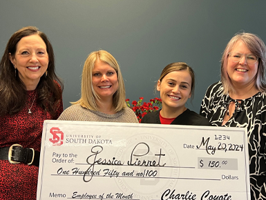 Jessica Pierret receives a check for her CSA employee of the month award.
