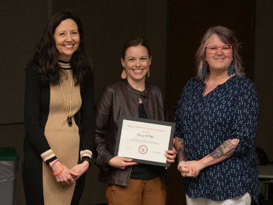 Jenny Wilka holds her CSA employee of the month award.