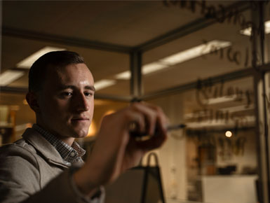 Caleb Swanson writing on a white board.