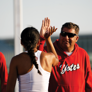 USD's Matayah Yellow Mule "high fives" Lucky Huber, USD track and field coach.
