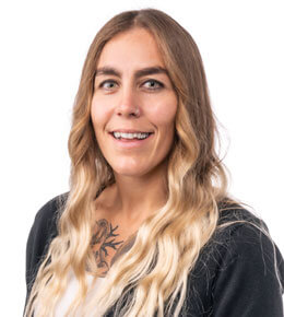 Melissa Dittberner sits for her professional photo. She is wearing a black and white shirt and is smiling at the camera.