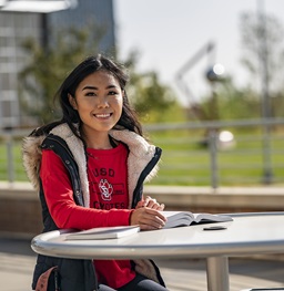 Female student at an outside table