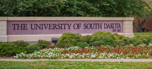 University Sign Behind Flower Bed.