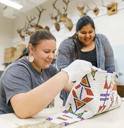 Two Students Examining a Native American Artifact