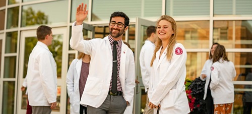 Medical Students Standing Outside of Building Smiling.